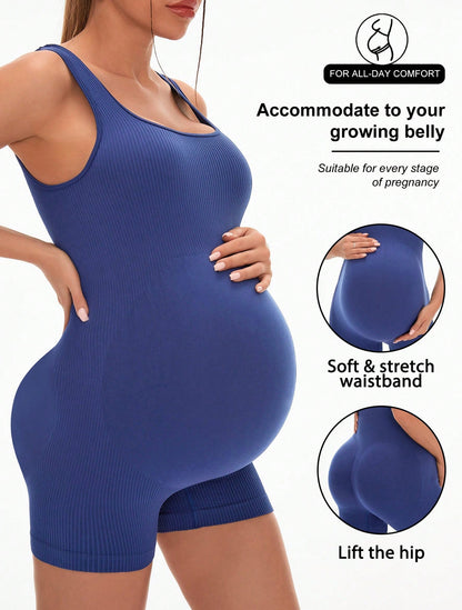 Maternity yoga bodysuit in navy worn over a pregnancy bump
